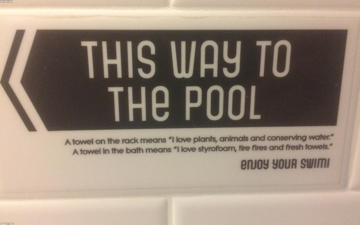 A stack of soft white bath towels in a bright bathroom