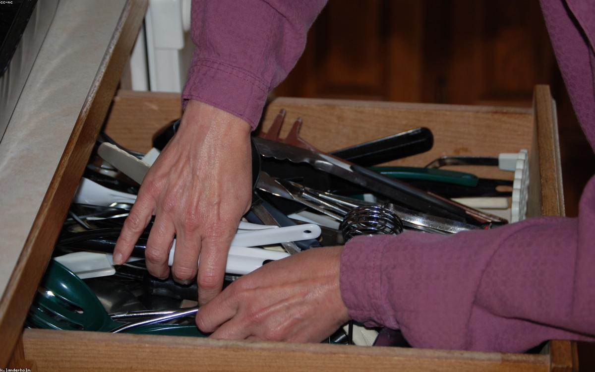 An organized kitchen drawer with utensils in bamboo dividers